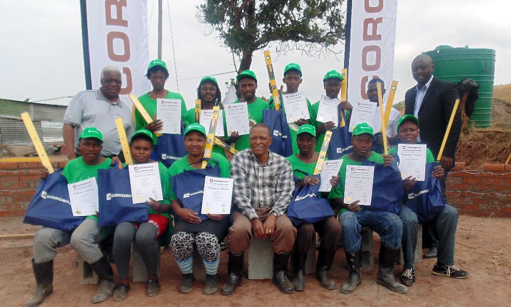 Back left is Derek Dimba. Back row right Lucas Nkhoesa, Corobrik Sales Representative.  Front centre Mthembeni Mkhize with twelve trainees who successfully completed the basic bricklaying course on site in the Maphumulo area of KwaZulu-Natal.