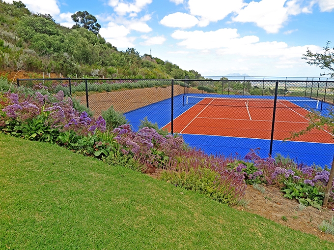 tennis court with a retaining wall and planter box