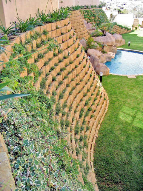 rockface retaining wall installation for a pool